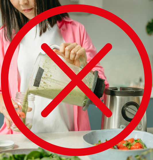 woman pouring puree from a blender with an overlaid red cross