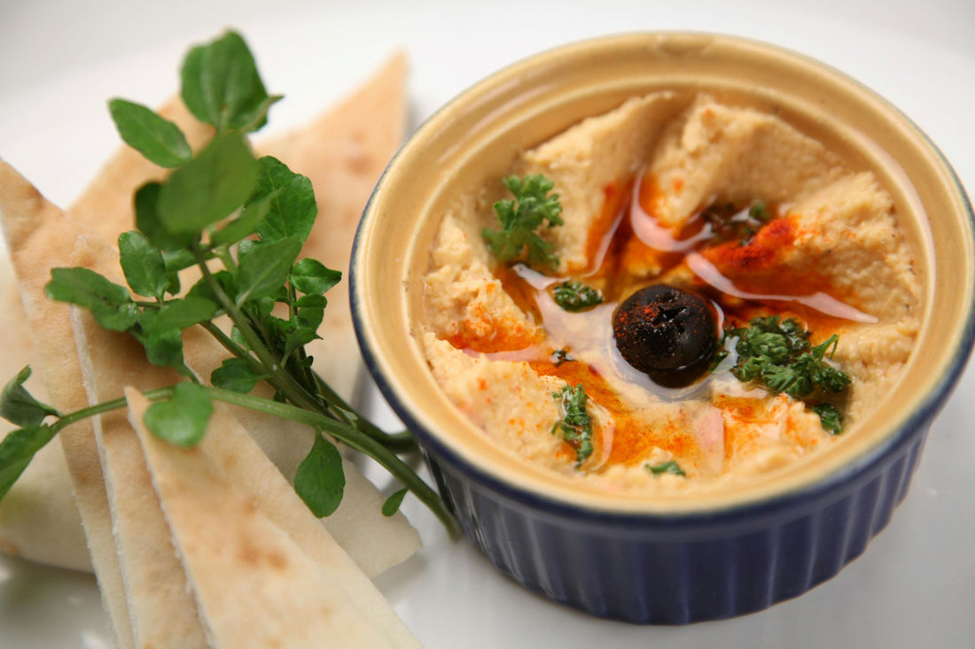 smooth hummus and bread pieces